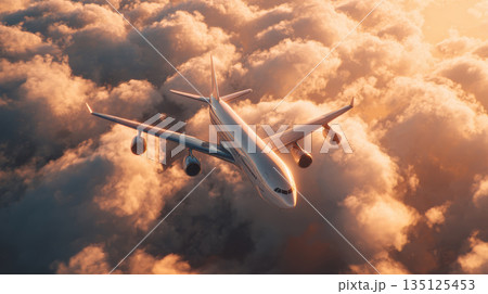 Airplane flying above clouds during golden hour with warm sunlight creating peaceful and majestic atmosphere 135125453