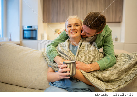 Cheerful couple man and woman embracing care and love, enjoying bonding and peaceful time at home. Cheerful couple man and woman embracing care and love, enjoying bonding and peaceful time at home. 135126419