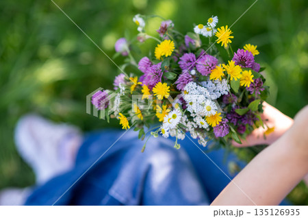 Close up of bouquet of wildflowers in womans hands 135126935