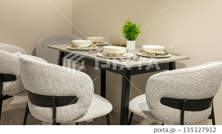 Cozy dining space with modern chairs and elegant table setting 135127912