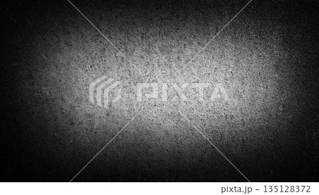 Dark concrete texture background with soft vignette light in the center. Rough matte surface with subtle grain and gradient shadows. Dark concrete texture background with soft vignette light in the center. Rough matte surface with subtle grain and gradient shadows. 135128372