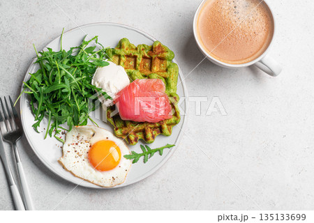 Healthy breakfast with green spinach waffles, salmon, cream cheese, fried egg and salad Healthy breakfast with green spinach waffles, salmon, cream cheese, fried egg and salad 135133699