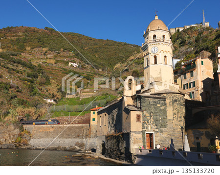 View of Vernazza, a town in Cinque Terre, from the mountain. Nature and sea, traditional buildings of Liguria, Italy. Architecture protected by UNESCO. Church of Santa Margherita. View of Vernazza, a town in Cinque Terre, from the mountain. Nature and sea, traditional buildings of Liguria, Italy. Architecture protected by UNESCO. Church of Santa Margherita. 135133720