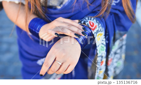 Bangladeshi girl wearing blue glass bangles and traditional saree in Moscow 135136716