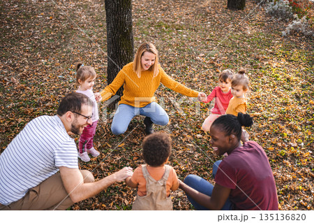 Circle of Fun: Family and Friends Enjoying Autumn Together 135136820