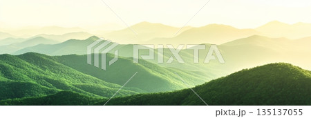 Stunning panoramic view of a vibrant green mountain range, bathed in the warm glow of the setting sun, creating a serene and captivating natural landscape Stunning panoramic view of a vibrant green mountain range, bathed in the warm glow of the setting sun, creating a serene and captivating natural landscape 135137055