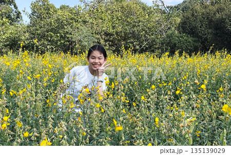 Joyful Asian Preteen Portrait in a Blooming Field 135139029