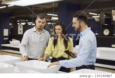 Consultant Assisting Couple In Plumbing Store Consultant Assisting Couple In Plumbing Store 135140967