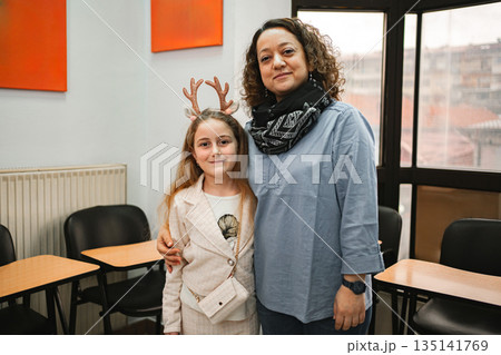Female teacher with elementary student at language school class Female teacher with elementary student at language school class 135141769
