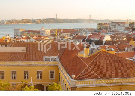 Lisbon cityscape with terracotta roofs and the Tagus River at sunset 135143008