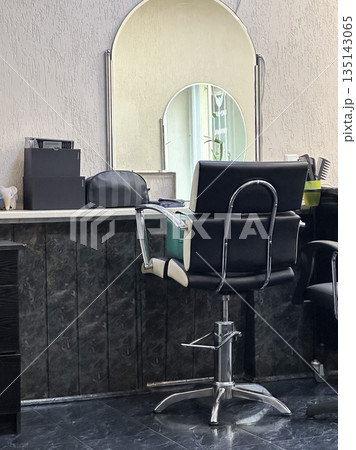 Modern salon chair with a mirror in a stylish beauty salon. Modern salon chair with a mirror in a stylish beauty salon. 135143065