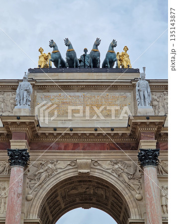Paris, France - December 10, 2025: the Arc de Triomphe du Carrousel reveals the intricate marble columns of neoclassical architecture and golden Quadriga statue atop the monument 135143877