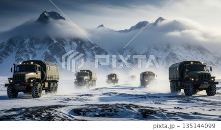 Military convoy traversing a snowy mountain pass in winter conditions 135144099