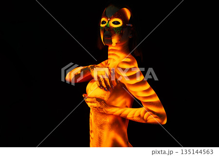 Fluorescent paint on a female breast and body. Fluorescent paint on a female breast and body. 135144563