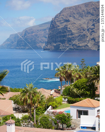 Ocean Cliffs and Terracotta Roofs in Tropical Coastal Town, Spain, Tenerife, Los Gigantes Ocean Cliffs and Terracotta Roofs in Tropical Coastal Town, Spain, Tenerife, Los Gigantes 135144694
