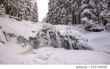 Beautiful Winter Frozen Waterfall Spruce Forest and Snow Cover 135144892