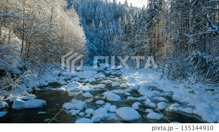 Beautiful Winter Mountain River Covered with Ice and Snow 135144910