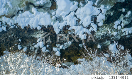 Beautiful Winter Mountain River Covered with Ice and Snow Beautiful Winter Mountain River Covered with Ice and Snow 135144911
