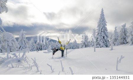 Beautiful Winter Mountain Scenery with Man on Snowshoes , Aerial Beautiful Winter Mountain Scenery with Man on Snowshoes , Aerial 135144931