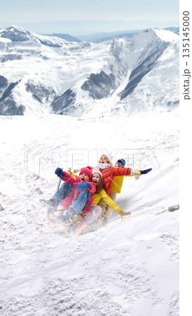 Energetic artwork of happy children sledding downhill in mountains. Energetic artwork of happy children sledding downhill in mountains. 135145000