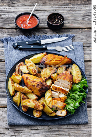 grilled juicy chicken breasts and roasted potatoes grilled juicy chicken breasts and roasted potatoes 135145069