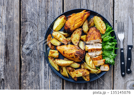 grilled juicy chicken breasts and roasted potatoes 135145076