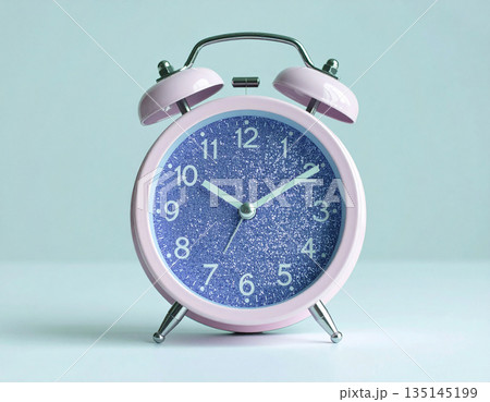 Metal violet alarm. Purple vintage alarm clock on background in pastel color with copy space. Bright design. 135145199