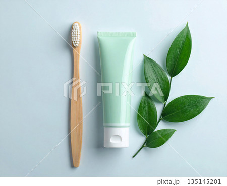 Medicine blogs. Minimalistic bamboo toothbrush with a tube of natural toothpaste on a white background. Health care. Oral hygiene. 135145201