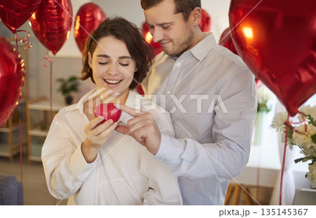 Happy Family Couple Holding Heart Gift On Valentine's Day Happy Family Couple Holding Heart Gift On Valentine's Day 135145367