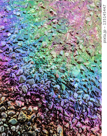 Oil Petrol Rainbow Leak Running over the road tarmac Oil Petrol Rainbow Leak Running over the road tarmac 135145447