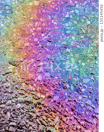 Oil Petrol Rainbow Leak Running over the road tarmac Oil Petrol Rainbow Leak Running over the road tarmac 135145450