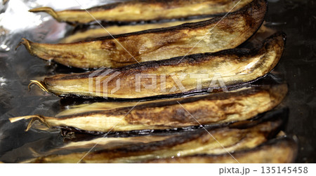 Close up of sliced and roasted aubergine eggplant vegetable Close up of sliced and roasted aubergine eggplant vegetable 135145458