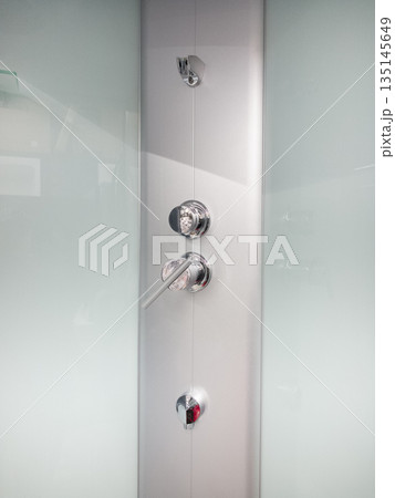 Modern shower control panel with sleek design and polished finish Modern shower control panel with sleek design and polished finish 135145649