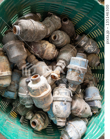 Old Brass Water Meters in Basket for Repair. 135146300