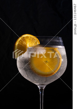 Gin and tonic drink with orange and ice Gin and tonic drink with orange and ice 135146467