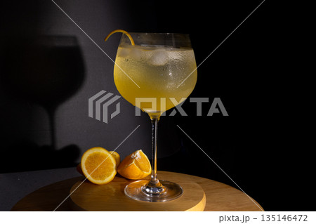 Refreshing gin tonic cocktail with orange peel garnish Refreshing gin tonic cocktail with orange peel garnish 135146472