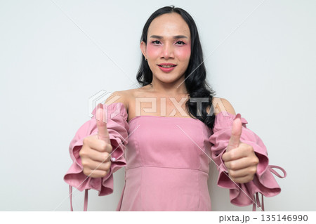 Portrait of a young Thai transgender person against white background with thumbs up gesture 135146990