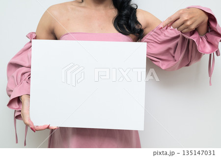 Thai transgender person against white background holding empty board with copy space 135147031