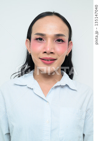 Portrait of a young Thai transgender person against white background Portrait of a young Thai transgender person against white background 135147040