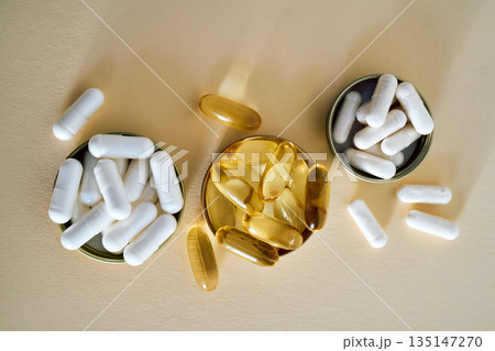 White capsules and omega 3 oil pills for health 135147270