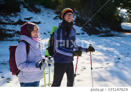 Winter Hiking Duo Outdoors With Snowy Trail, Backpacks, And Trekking Poles Winter Hiking Duo Outdoors With Snowy Trail, Backpacks, And Trekking Poles 135147629