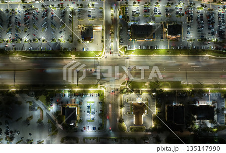 Aerial view of shopping plaza stores and American wide highway with many driving cars in North Port, Florida 135147990