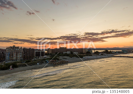 Aerial view of Pomorie city that is located on Black Sea shore. Top view of sand beaches with many hotel buildings and tourist infrastructure. Aerial view of Pomorie city that is located on Black Sea shore. Top view of sand beaches with many hotel buildings and tourist infrastructure. 135148005