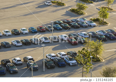 Aerial view of dealership parking lot with many brand new cars for sale. Development of american automotive industry concept 135148105