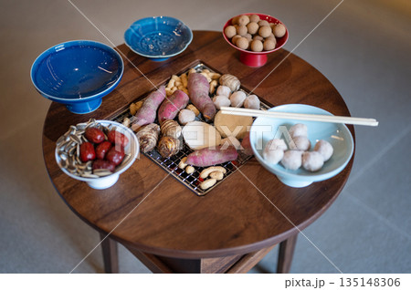 Colorful Traditional Sweets And Fruits Displayed Artfully On Charcoal Grill Round Table 135148306