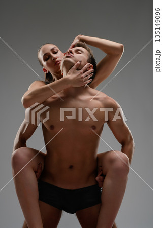 Sensual woman embracing a muscular man from behind in an artistic pose Sensual woman embracing a muscular man from behind in an artistic pose 135149096