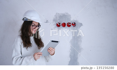 Female engineer wearing helmet and using tablet during construction inspecting electrical system Female engineer wearing helmet and using tablet during construction inspecting electrical system 135150280