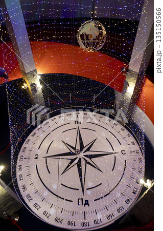 Indoor Christmas installation with glowing garlands and lighting effects. Indoor Christmas installation with glowing garlands and lighting effects. 135150566