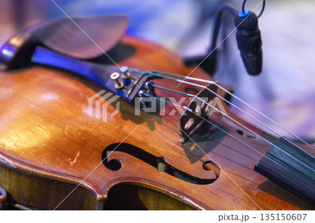 A violin lies on a chair on stage before a concert 135150607