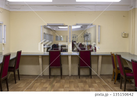 a dilapidated old dressing room in a theater with mirrors and chairs 135150642